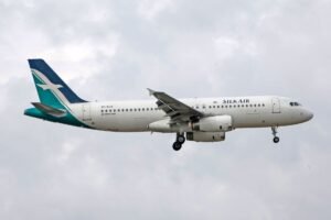 SIA Training Booking - SilkAir Airbus A320 captured mid-flight, silhouetted against a cloudy sky.
