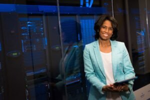 Cybersecurity for Senior Leaders - Smiling woman in data center showcasing technology expertise.