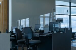The Reception Workstation Certification - A contemporary airport boarding counter with glass dividers and computers, ready for passengers.