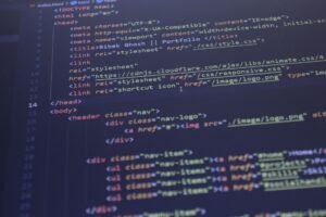 Web Applications Certification - Close-up view of HTML and CSS code displayed on a computer screen, ideal for programming and technology themes.