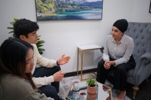 Professional Relationship Counselling Certification - A couple in a therapy session discussing issues with a therapist in a modern office.