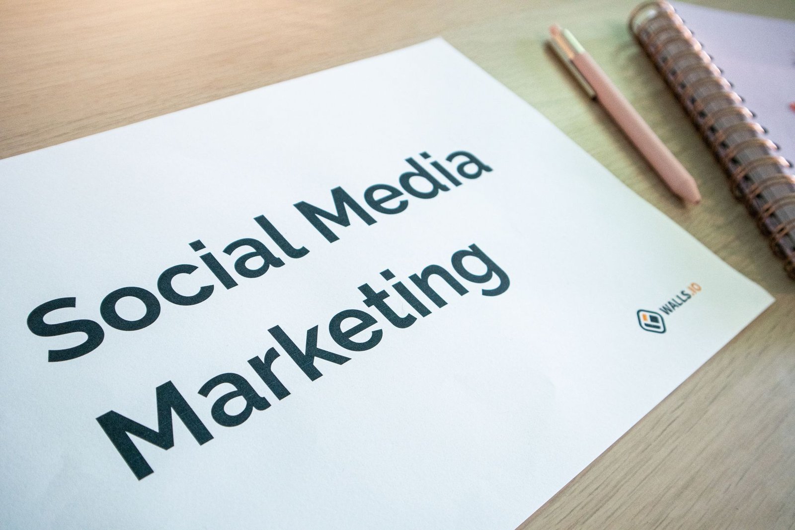 Social Media for Business - Close-up of a social media marketing document on a desk with a pen and notebook.