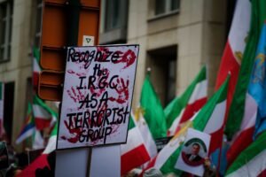 Extremism and Terrorism Awareness Certification - Protest in Brussels with flags and signs demanding IRGC recognition as a terrorist group.