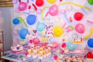 Cupcake Decorating – Birthday Ideas Pack 2 - Colorful birthday dessert table with balloons and cake in festive setting.
