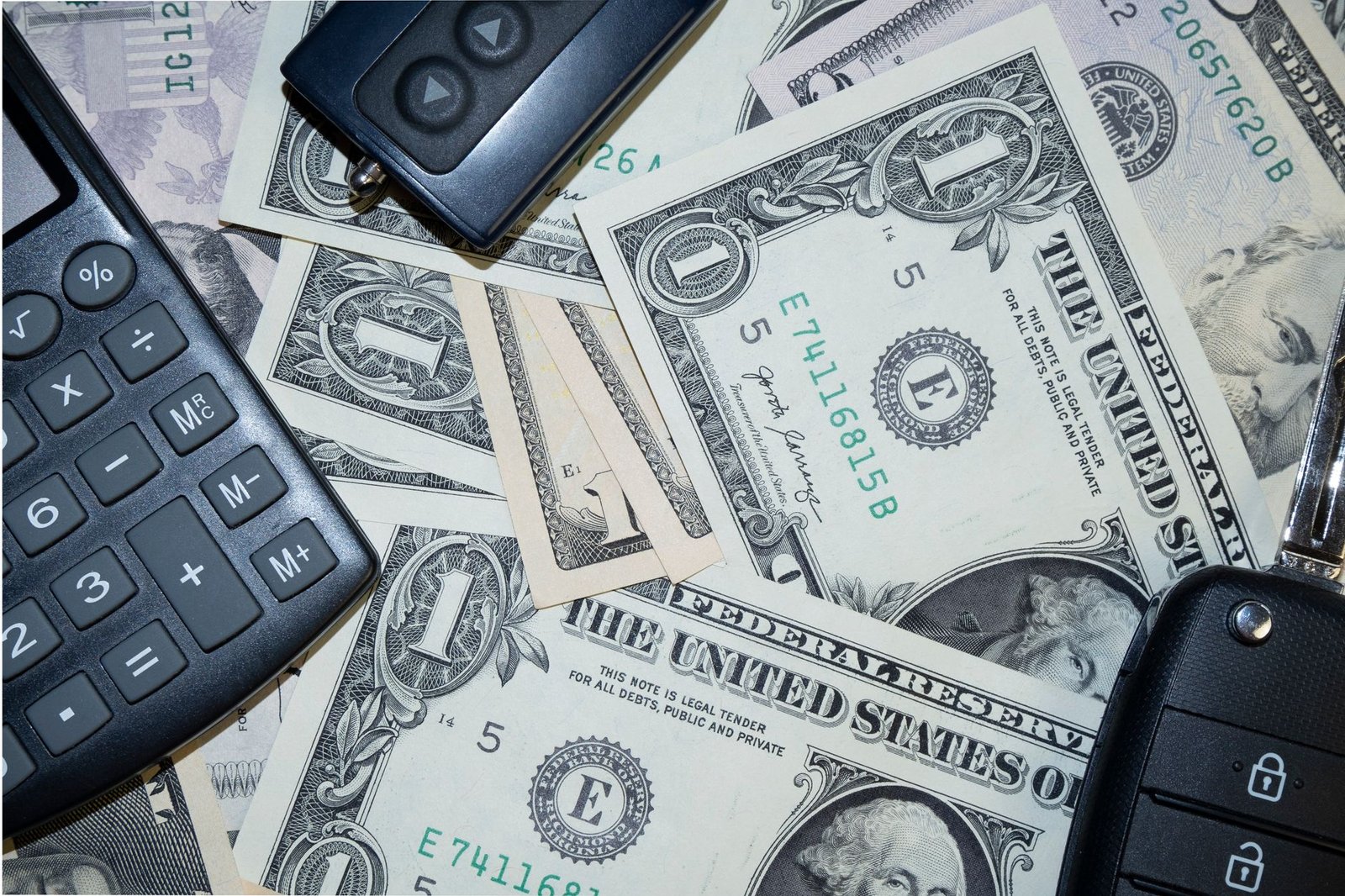 Key Account Management Certification - An arrangement of US dollar bills, car keys, and a calculator representing finance and investment concepts.