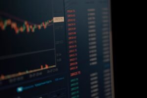 The Financial Services and Markets Act Certification - Close-up of a computer screen showing dynamic financial market data and charts, indicating real-time trading updates.