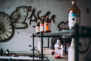 COSHH Awareness Certification - Discover an abandoned industrial room featuring shelves of toxic chemical bottles and graffiti walls.