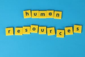 Defining HR Certification - Yellow tiles spelling 'human resources' on a blue background, ideal for HR or business concepts.