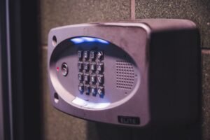 Access Controls - A close-up image of an illuminated security keypad mounted on a wall.