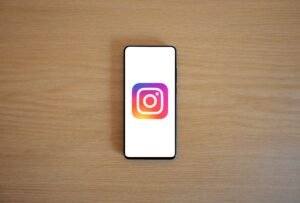 Instagram Marketing Certification - A smartphone with the Instagram logo on display, placed on a wooden surface. Perfect for technology and social media themes.