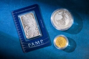 Investing in Gold and Silver Certification - Silver bar and coins on blue surface, highlighting investment and collectible value.