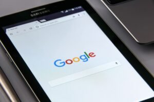 Introduction to Google Ads Certification - Close-up of a tablet displaying Google's search screen, emphasizing technology and internet browsing.