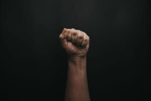 Advanced Resistance Training Certificate - A powerful image of a raised fist against a dark background, symbolizing strength and unity.