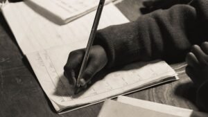Writing Skills Certification - Close-up of a child writing in a notebook, focusing on handwriting practice.