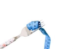 Nutrition and Weight Management Certificate - A fork entwined with a blue measuring tape, symbolizing dieting and weight management.