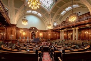 Information Governance Certification - A beautifully designed chamber room with ornate woodwork and chandeliers in the UK.