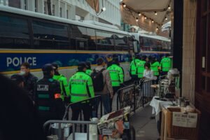 Crowd Management Certification - Police officers in high-visibility vests patrol a busy street in Seoul, South Korea.