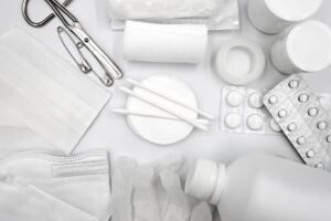 Mental Health First Aid Certification - A flat lay of essential first aid supplies including bandages, gloves, and medications.