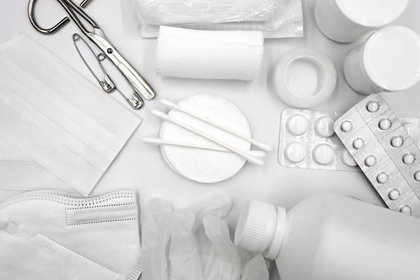 Mental Health First Aid Certification - A flat lay of essential first aid supplies including bandages, gloves, and medications.