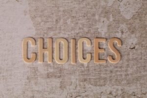 Effective Decision Making Certification - Wooden letters spelling 'choices' on a textured surface, symbolizing decision-making.