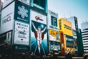The Purpose of Advertising Certification - Colorful billboards and signs in a busy cityscape, capturing urban advertising.