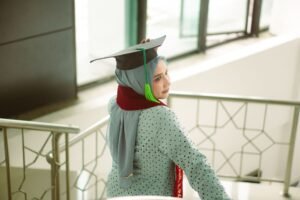 Interior Design Diploma - A young woman in a hijab wears a graduation cap, symbolizing success and achievement.
