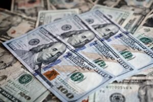 The National Minimum Wage Certification - Close-up of various US dollar bills highlighting finance and economy.