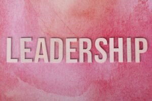 Inspirational Leadership Certification - Inspirational leadership text on a vibrant pink watercolor background.