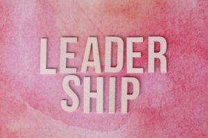 Practical Leadership Skills Certification - Text 'Leadership' on a textured pink background illustrating influence.