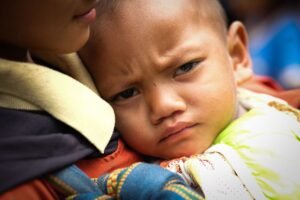 Child Protection Certification - Close-up of a child being comforted, showcasing emotion and warmth.