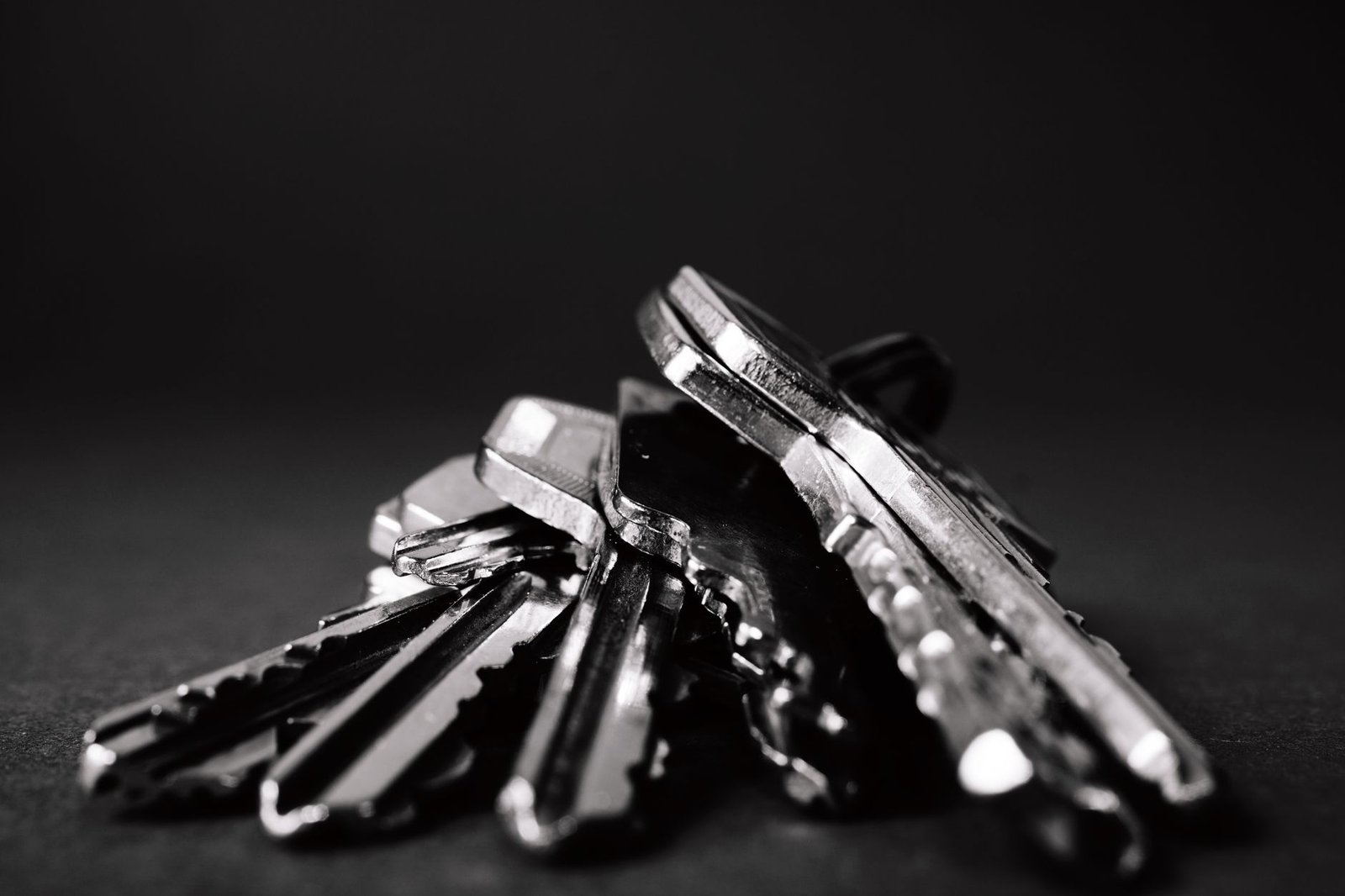 Key Tools and Knowledge for Team Leading Certification - A close-up shot of a pile of metallic keys on a dark surface, emphasizing security and precision.