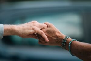 Privacy and Dignity in Care Certification - A heartfelt image of two elderly individuals holding hands, symbolizing love and support.
