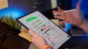 Time and Priority Management Certification - A person managing tasks on a tablet with a digital pen in a modern office setting.