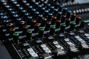 Introduction to Gaining a Cisco Certification - Detailed view of an audio mixing console with colorful lights in a professional studio setting.