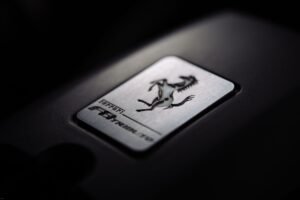 Online Reputation Management Certification - Close-up of a metallic car logo badge with a prancing horse, symbolizing luxury and speed.