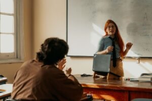 Lesson Planning for Teachers Certification - Teacher engages with student during a lesson at a Buenos Aires university classroom.