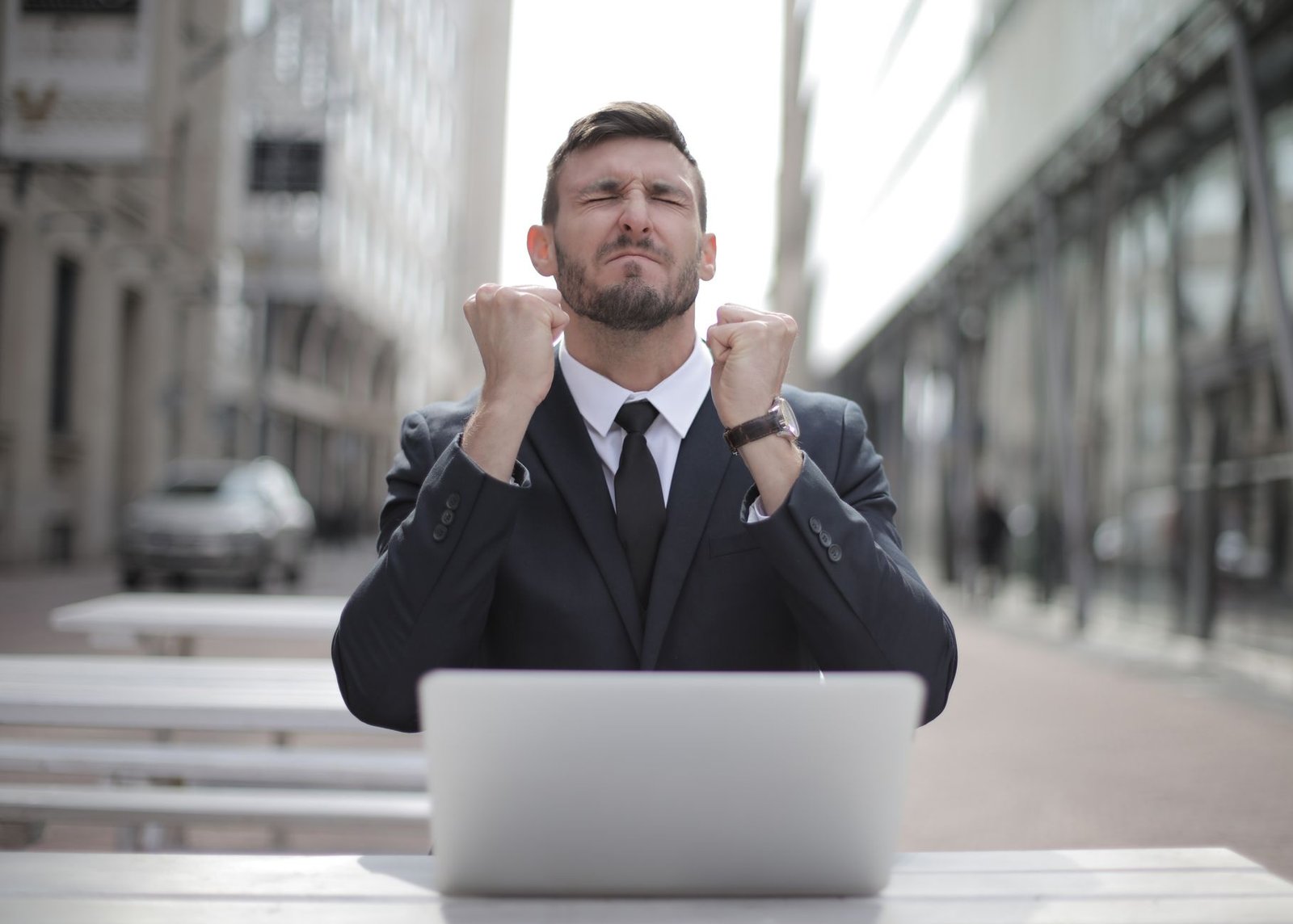 Finding Your Perfect Career For Success and Enjoyment Training - Confident businessman in Budapest celebrates success with a fist pump, reflecting a professional achievement.
