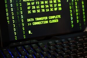 The General Data Protection Regulation Certification - Data transfer complete message displayed on a computer monitor with a keyboard underneath.