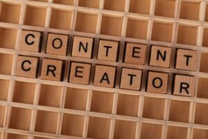 Content Creation Certification - Wooden block letters spelling 'Content Creator' on a grid background. Ideal for digital marketing themes.