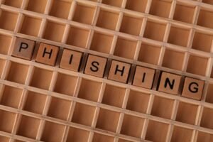 Phishing Fears - High-angle view of wooden letter tiles spelling 'Phishing', representing online security threats.