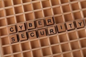 Cybersecurity Quick Wins - Wooden blocks spelling 'Cyber Security' on a wooden grid background.
