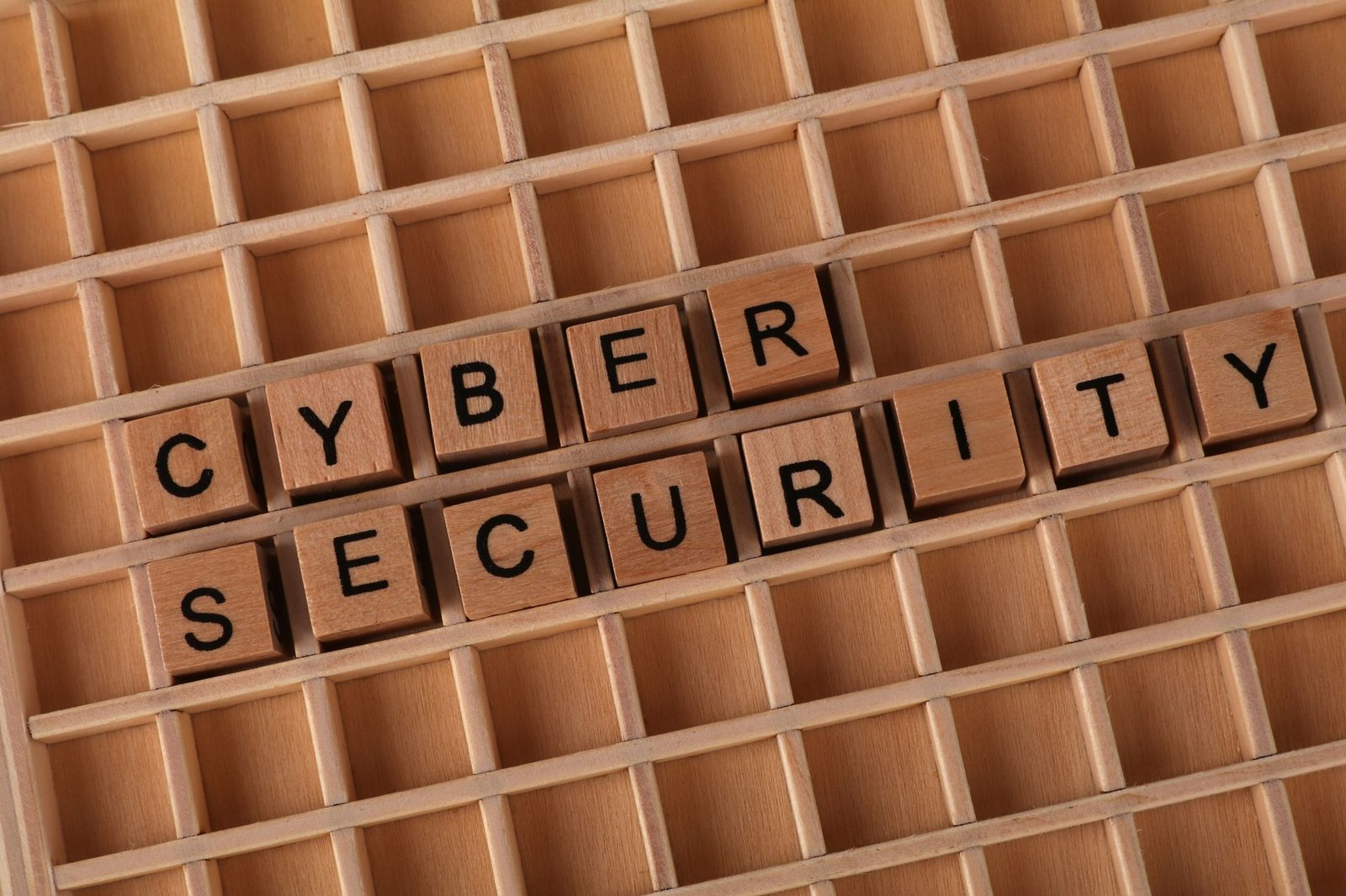 Cybersecurity Quick Wins - Wooden blocks spelling 'Cyber Security' on a wooden grid background.