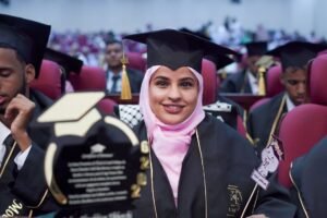 Autobiography Writing Diploma - Smiling graduates in caps and gowns at a ceremony, representing academic achievement and celebration.