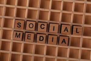 Social Media Marketing Certification - Close-up of wooden letter blocks spelling 'Social Media' on a wooden grid.