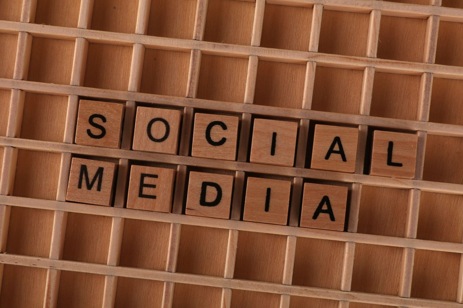 Social Media Marketing Certification - Close-up of wooden letter blocks spelling 'Social Media' on a wooden grid.
