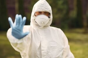 Health and Safety – We Are All Responsible Certification - Person in protective equipment outdoors with hand raised, symbolizing caution and safety.