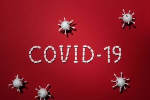 Coronavirus Awareness Certification – Covid – CV19 - Artistic representation of COVID-19 using pills and virus models on red background.