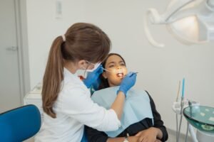Dental Care Certification - Dentist conducting a dental examination on a patient in a modern clinic setting.