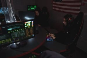 Introduction to Cybersecurity - Cybersecurity professionals working on computer systems, focusing on data protection in a dimly lit room.