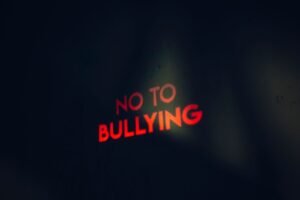 Bullying in Schools Awareness and Prevention Certification - Image featuring a strong anti-bullying message boldly lit on a dark background.